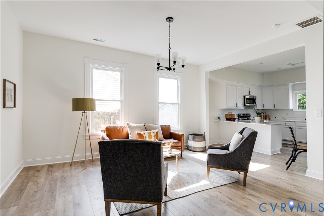 2413 Ingram Avenue Richmond, VA 23224 - Photo 8 of 43 a living room with furniture and a chandelier