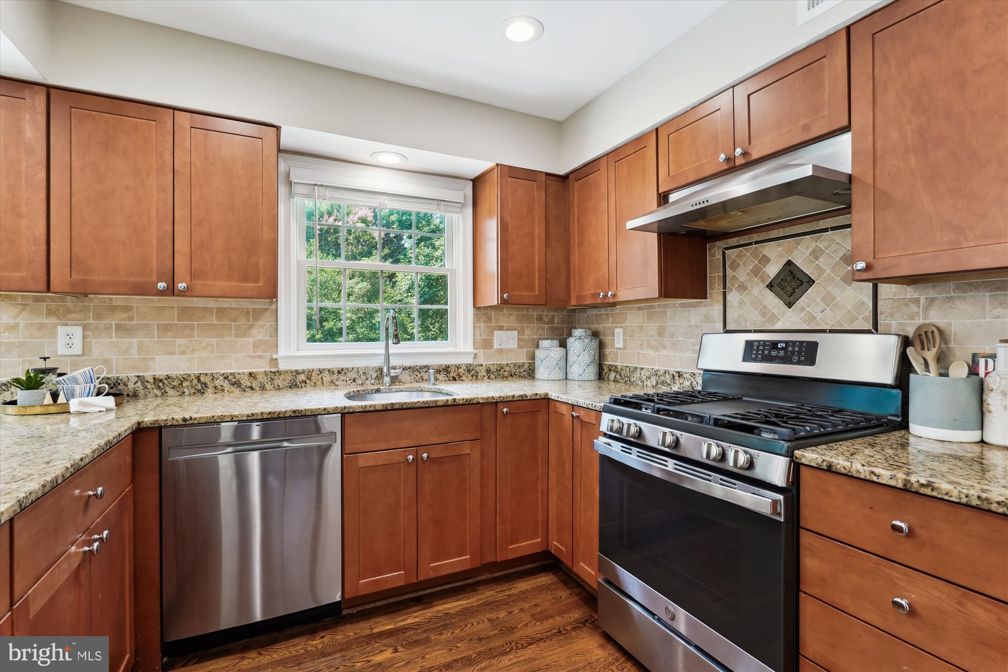 5427 Rilian Court Burke, VA 22015 - Photo 12 of 63 a kitchen with stainless steel appliances granite countertop wooden cabinets stove top oven and sink