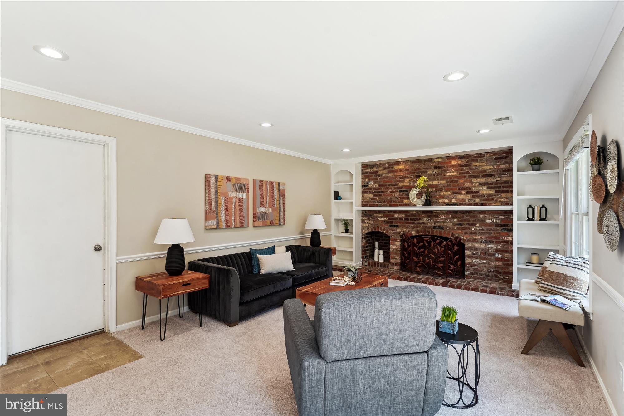 5427 Rilian Court Burke, VA 22015 - Photo 16 of 63 a living room with furniture a fireplace and a flat screen tv