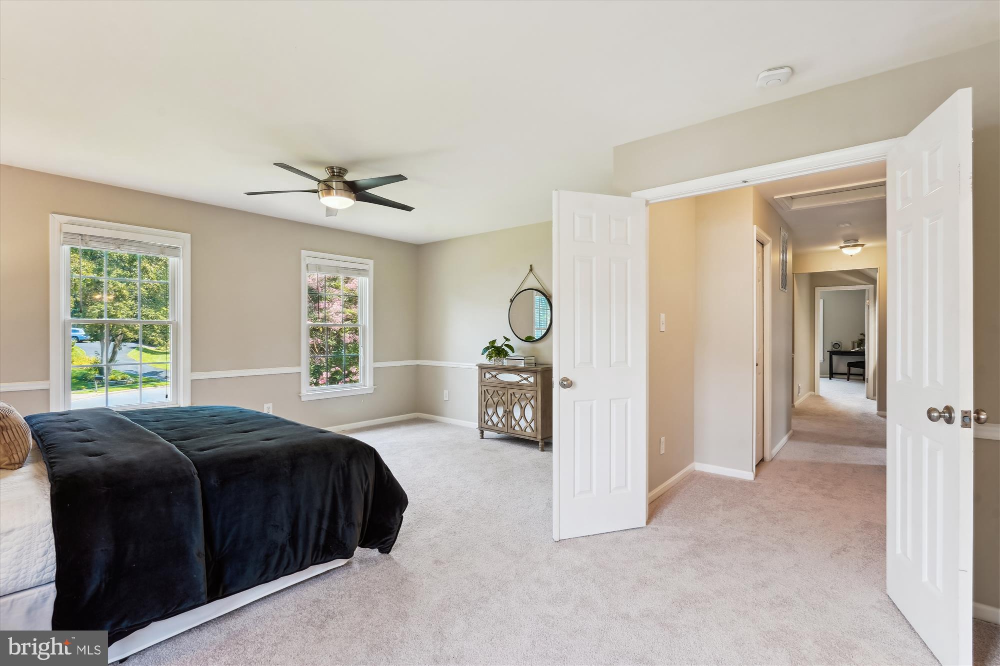5427 Rilian Court Burke, VA 22015 - Photo 20 of 63 a spacious bedroom with a bed and a chandelier