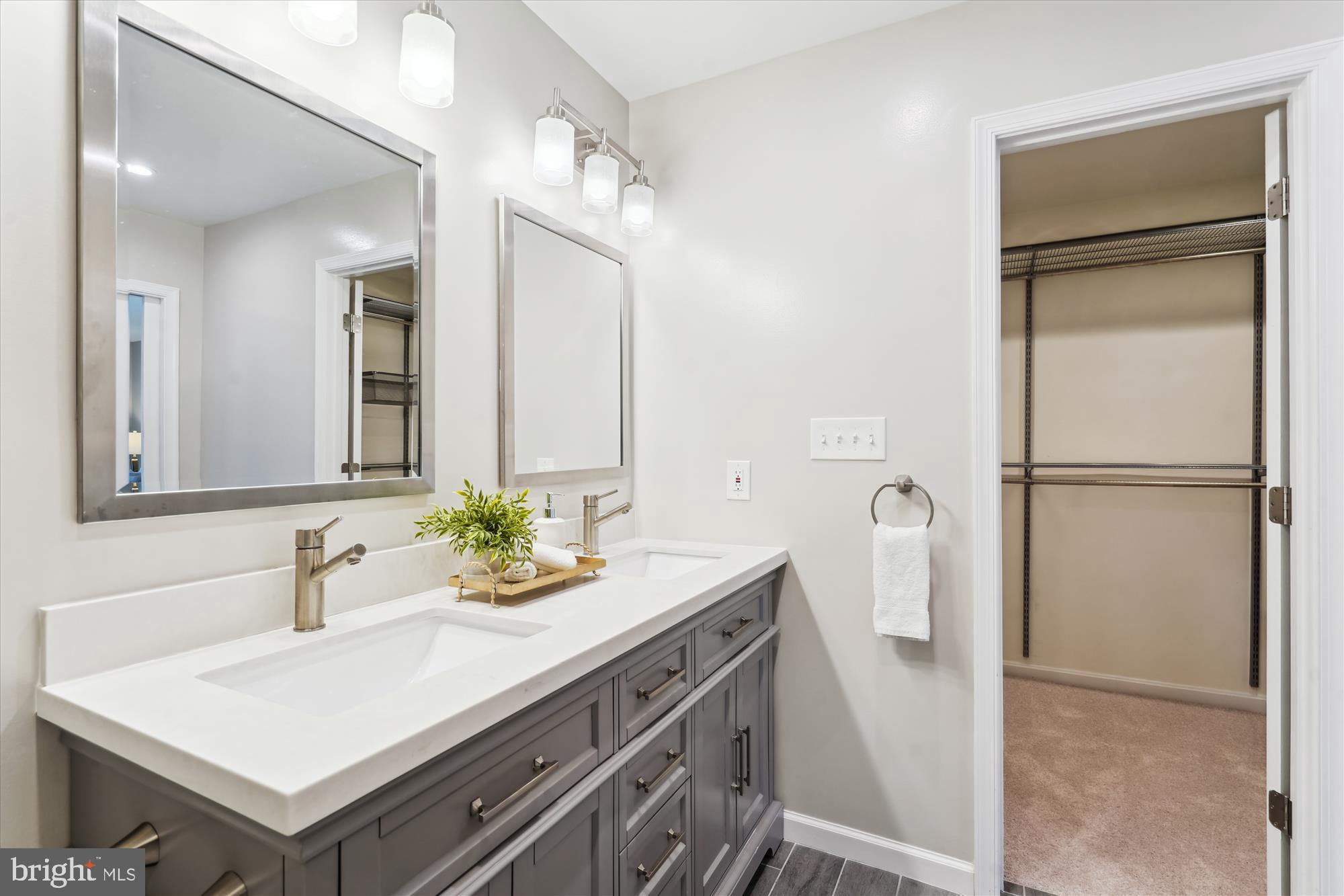 5427 Rilian Court Burke, VA 22015 - Photo 23 of 63 a bathroom with a sink a mirror and a shower