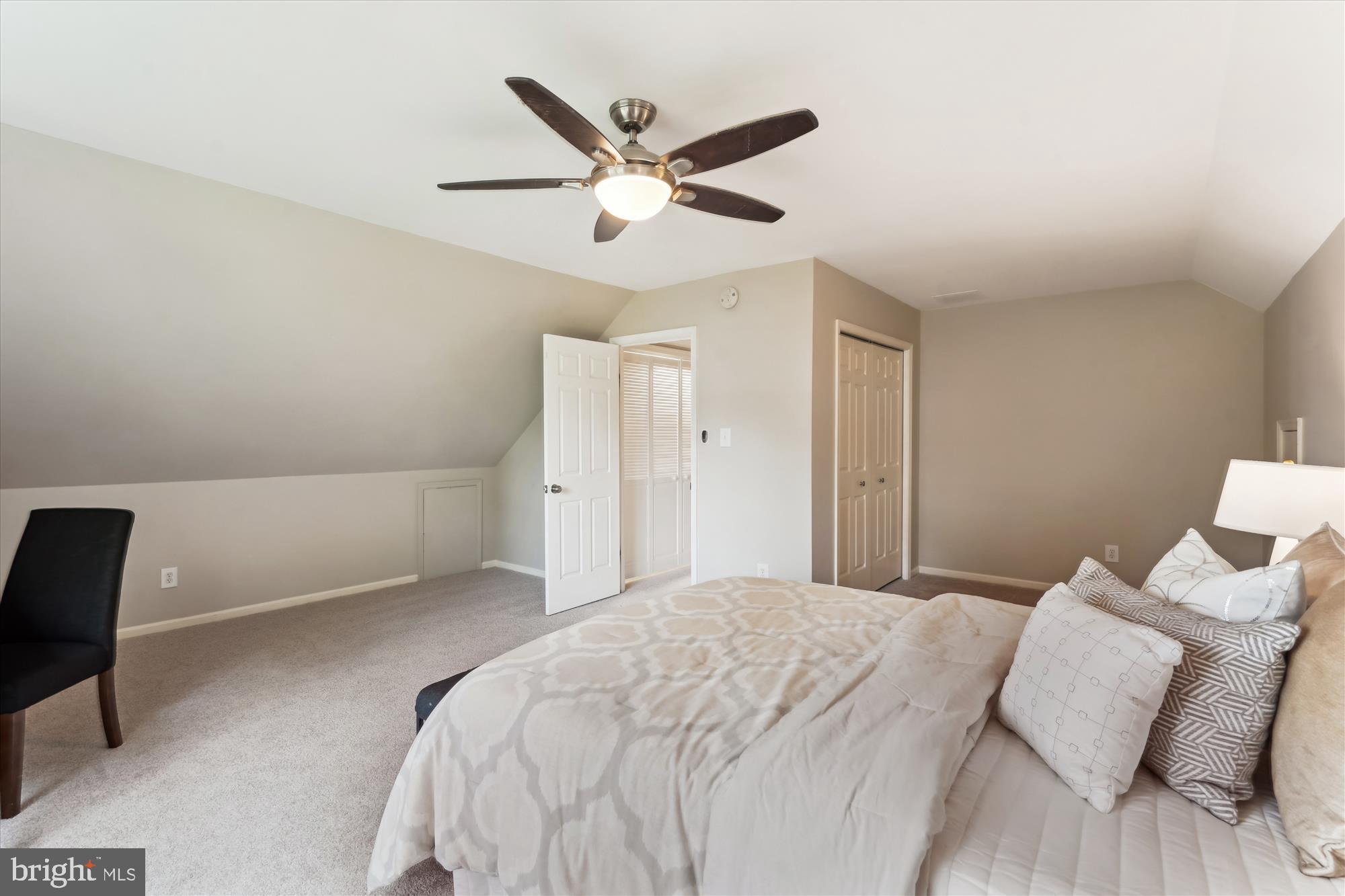 5427 Rilian Court Burke, VA 22015 - Photo 26 of 63 a bedroom with a large bed and a ceiling fan