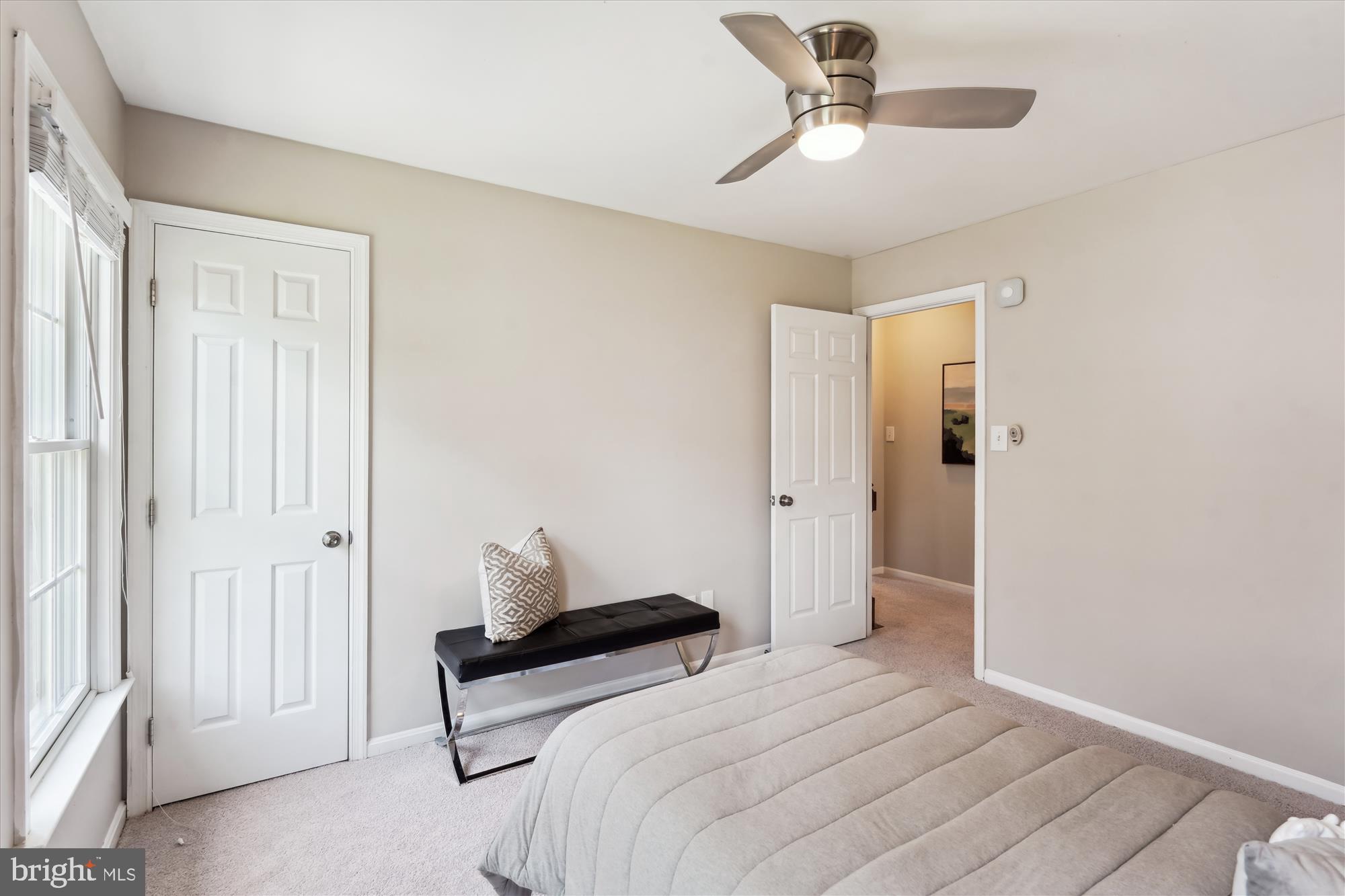 5427 Rilian Court Burke, VA 22015 - Photo 30 of 63 a bedroom with a bed and a chandelier