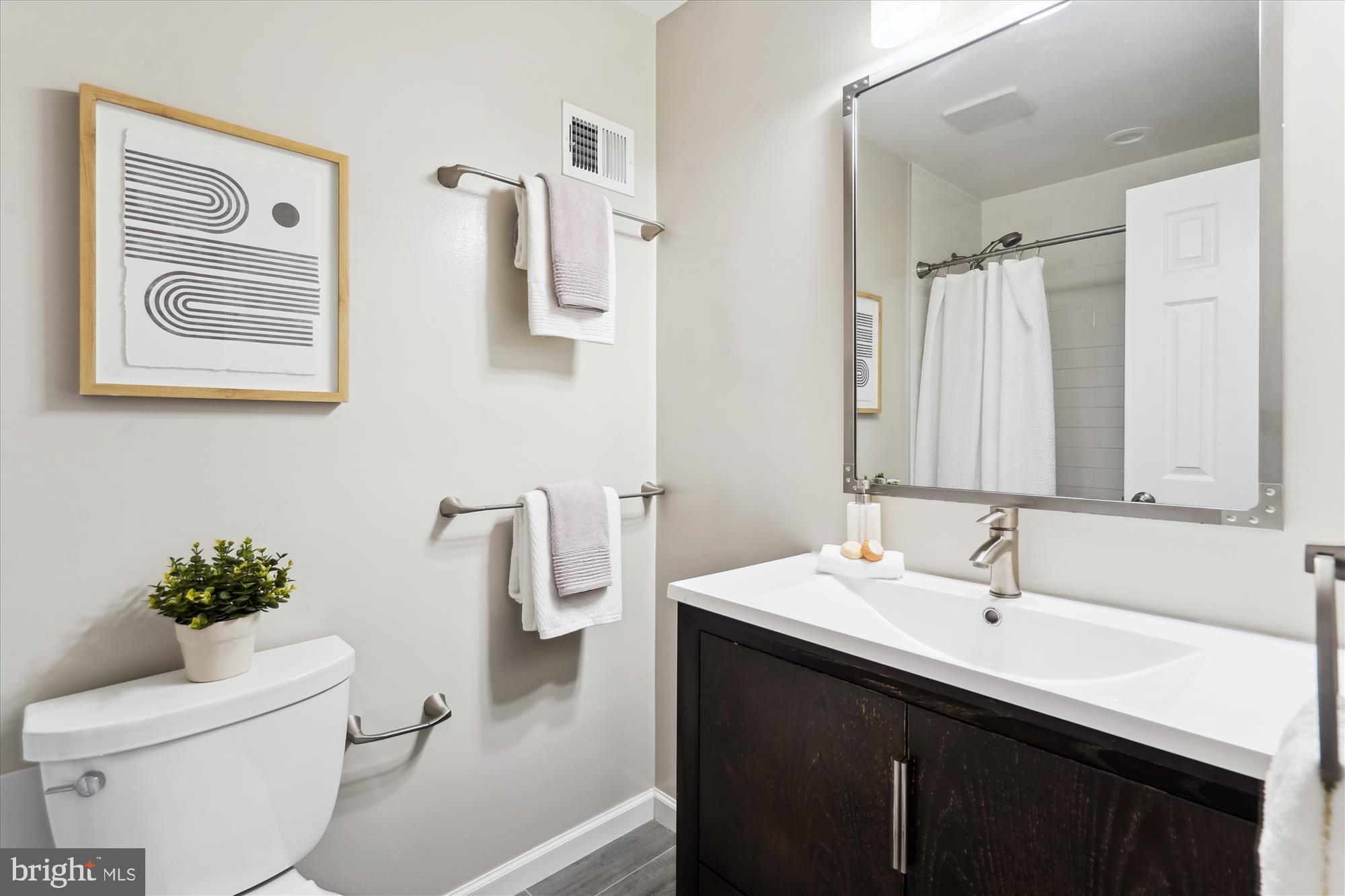 5427 Rilian Court Burke, VA 22015 - Photo 34 of 63 a bathroom with a sink a toilet and a mirror