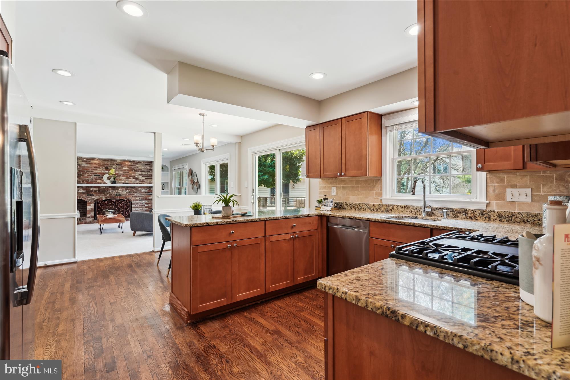 5427 Rilian Court Burke, VA 22015 - Photo 9 of 63 a kitchen with stainless steel appliances granite countertop a stove a sink dishwasher and a refrigerator with wooden cabinets