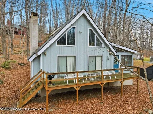 a roof deck with table and chairs