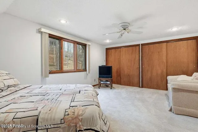 a bedroom with a bed dresser and a window