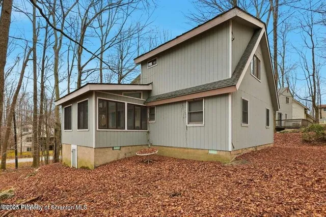 a roof deck with table and chairs