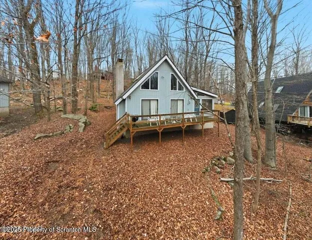 a white house with a large tree in front of it