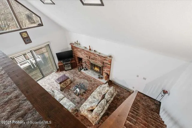 a bed sitting in a bedroom next to a lamp with a rug