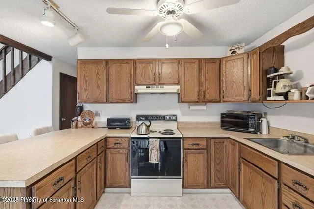 a kitchen with a sink a stove and cabinets