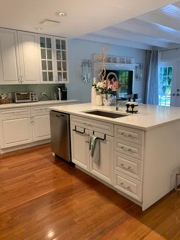 a kitchen with a sink cabinets and window