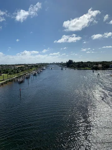 a view of a lake with houses in back