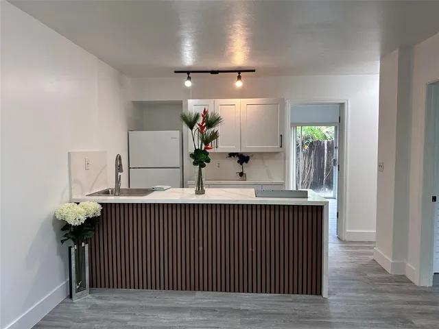 a view of kitchen with furniture and wooden floor