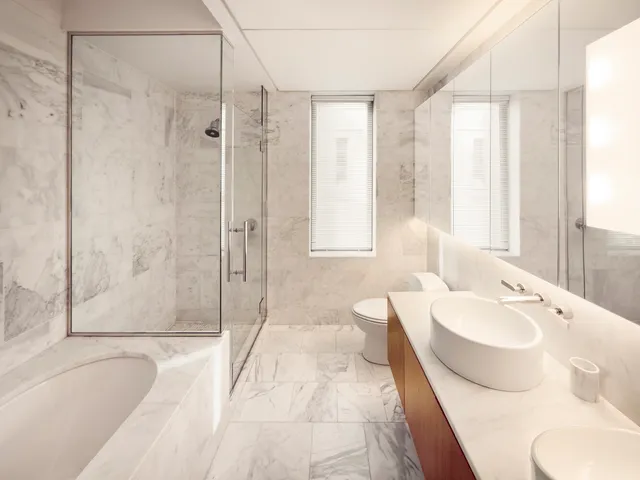 a spacious bedroom with a large bed and a large window with outer view