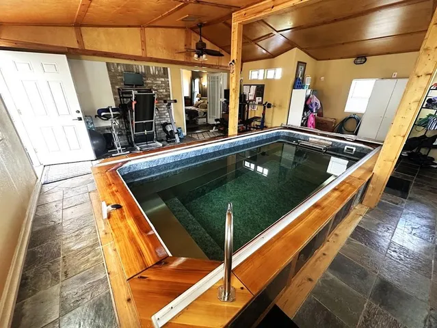 a view of a swimming pool with a yard