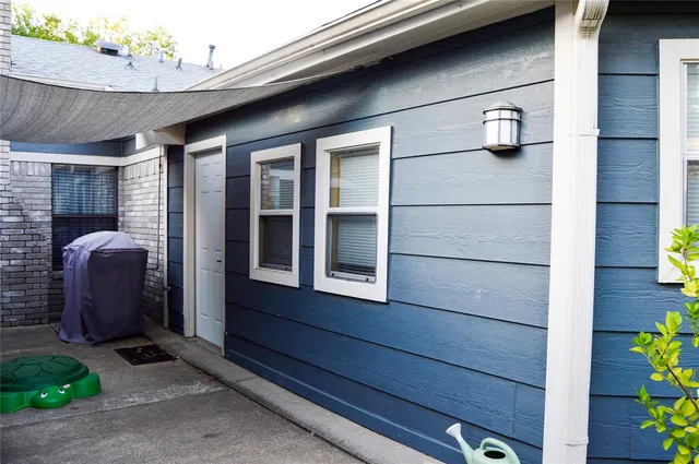 a view of a backyard with table and chairs and a large tree