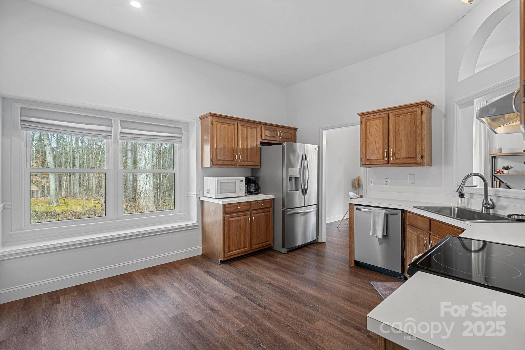 120 Banks Ridge Road Fort Mill, SC 29715 - Photo 14 of 37 a kitchen with a wooden floor and stainless steel appliances