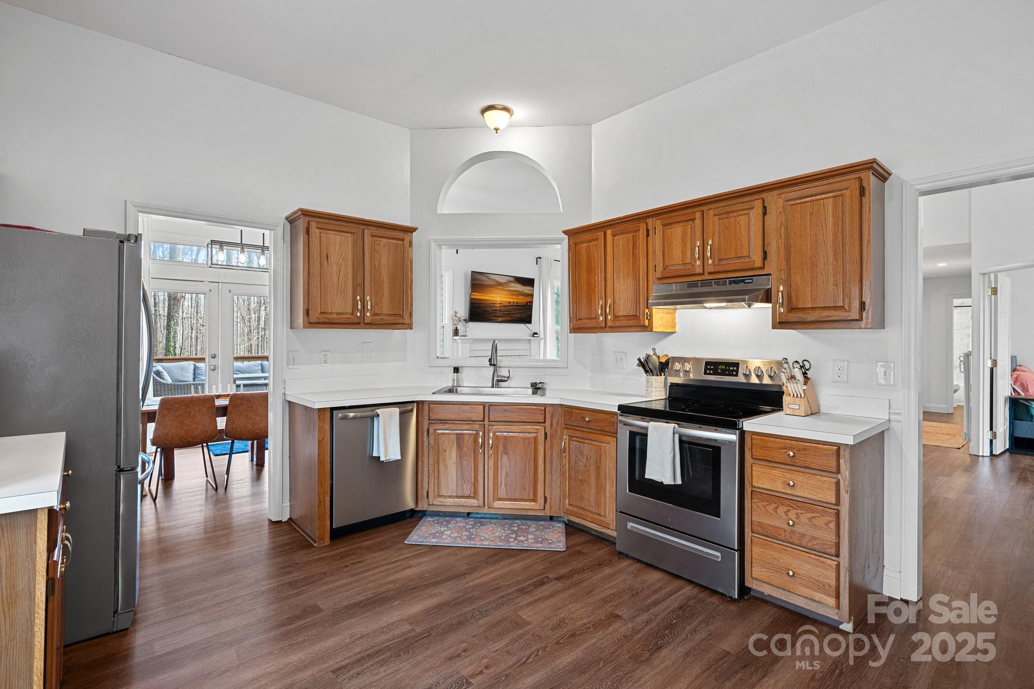 120 Banks Ridge Road Fort Mill, SC 29715 - Photo 9 of 37 a kitchen with stainless steel appliances granite countertop a stove top oven a sink dishwasher and a microwave oven with wooden floor