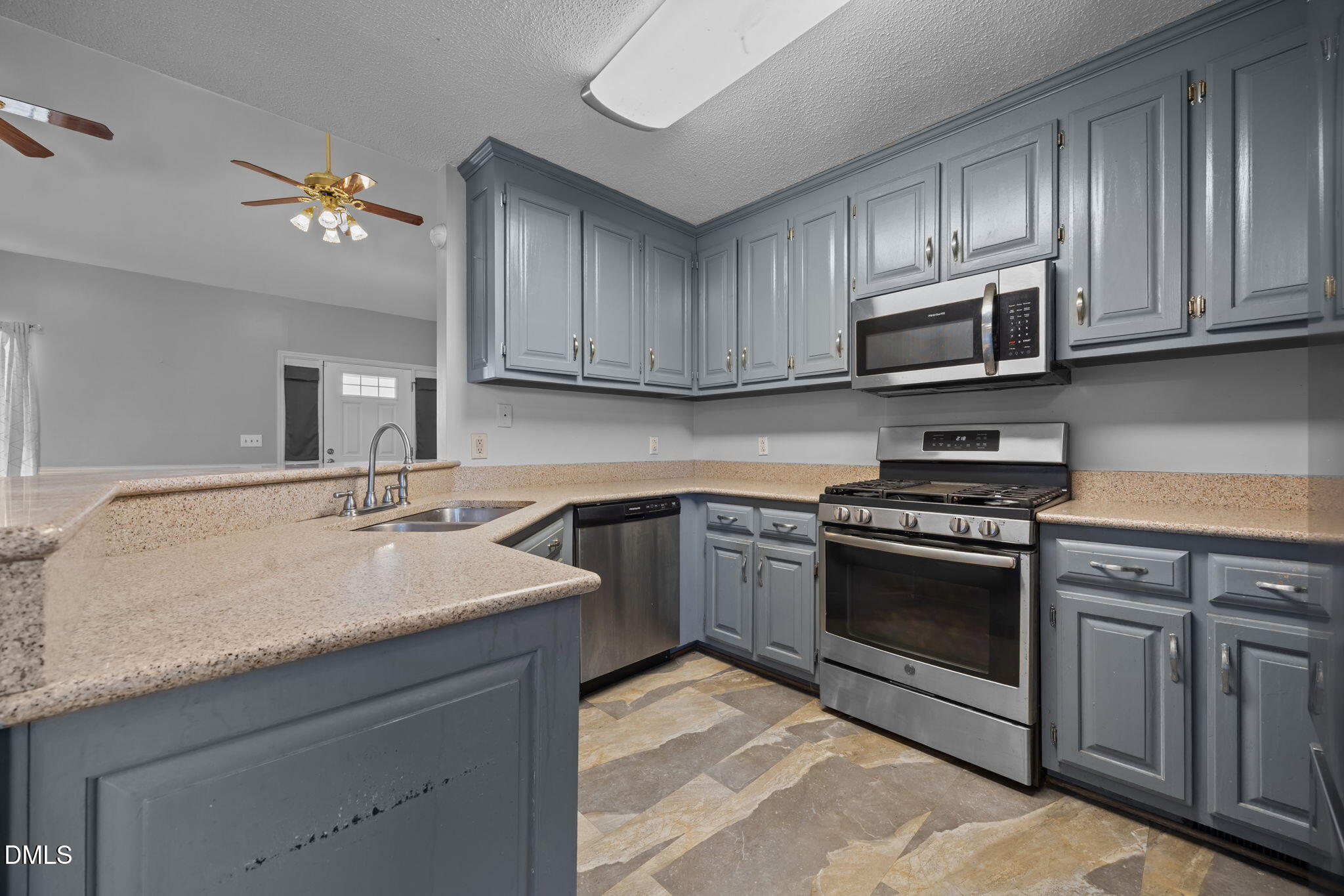 3431 Old Stage Road South Erwin, NC 28339 - Photo 12 of 53 a kitchen with stainless steel appliances granite countertop a sink dishwasher a stove and a microwave oven with cabinets