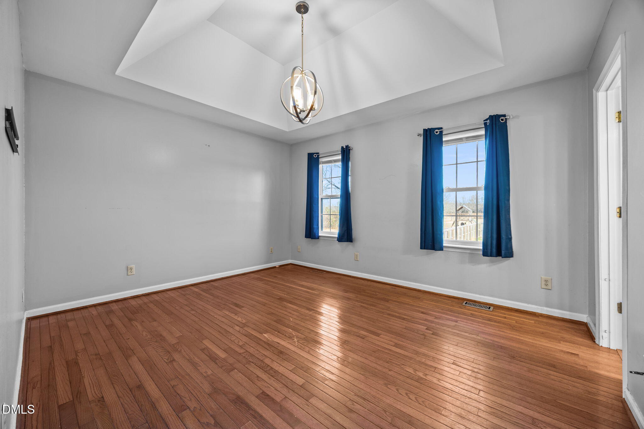 3431 Old Stage Road South Erwin, NC 28339 - Photo 19 of 53 an empty room with wooden floor chandelier and windows