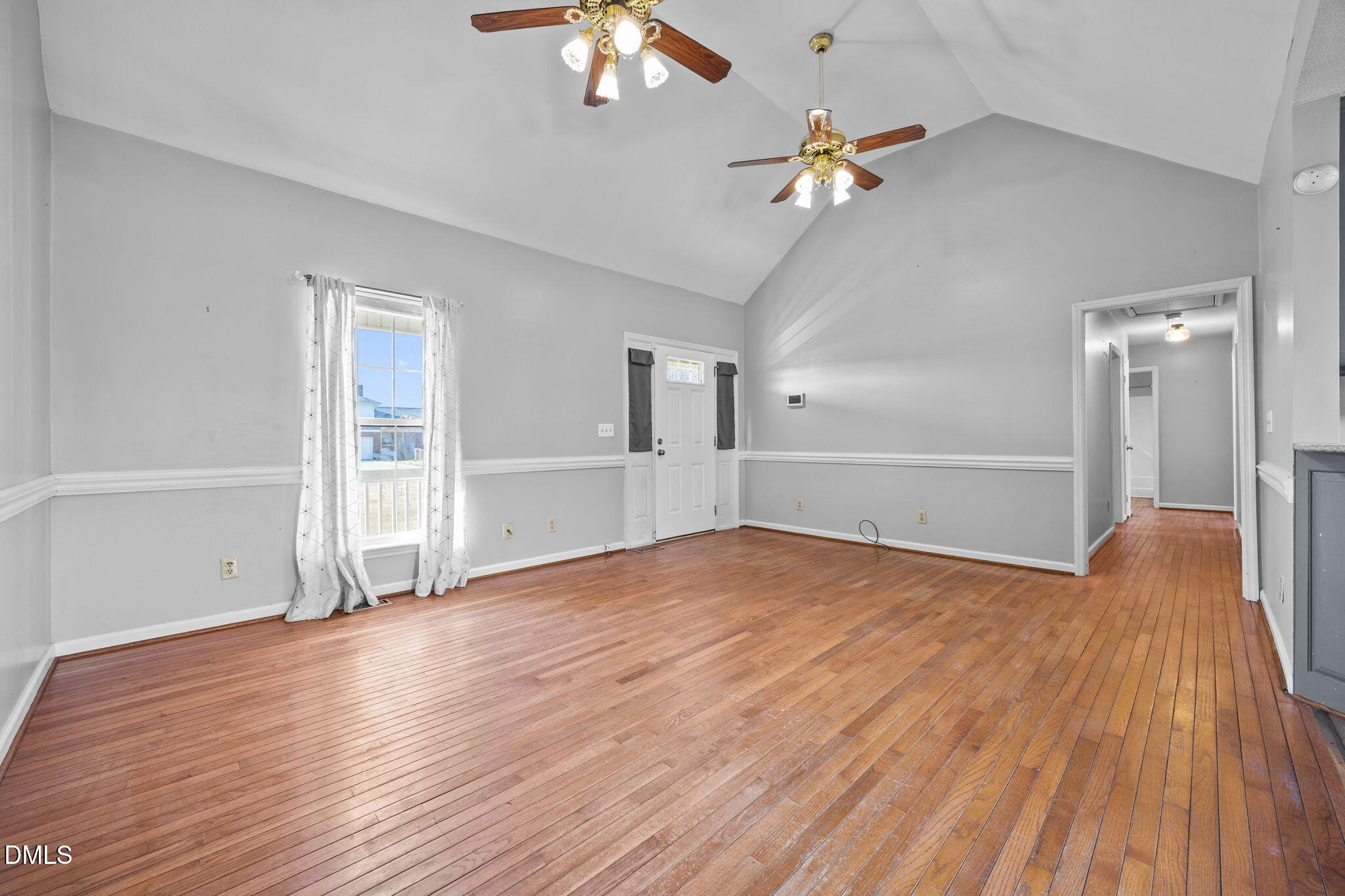 3431 Old Stage Road South Erwin, NC 28339 - Photo 5 of 53 an empty room with wooden floor chandelier fan and windows