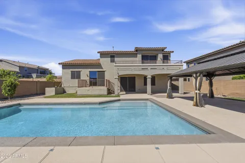 a view of house with swimming pool and porch
