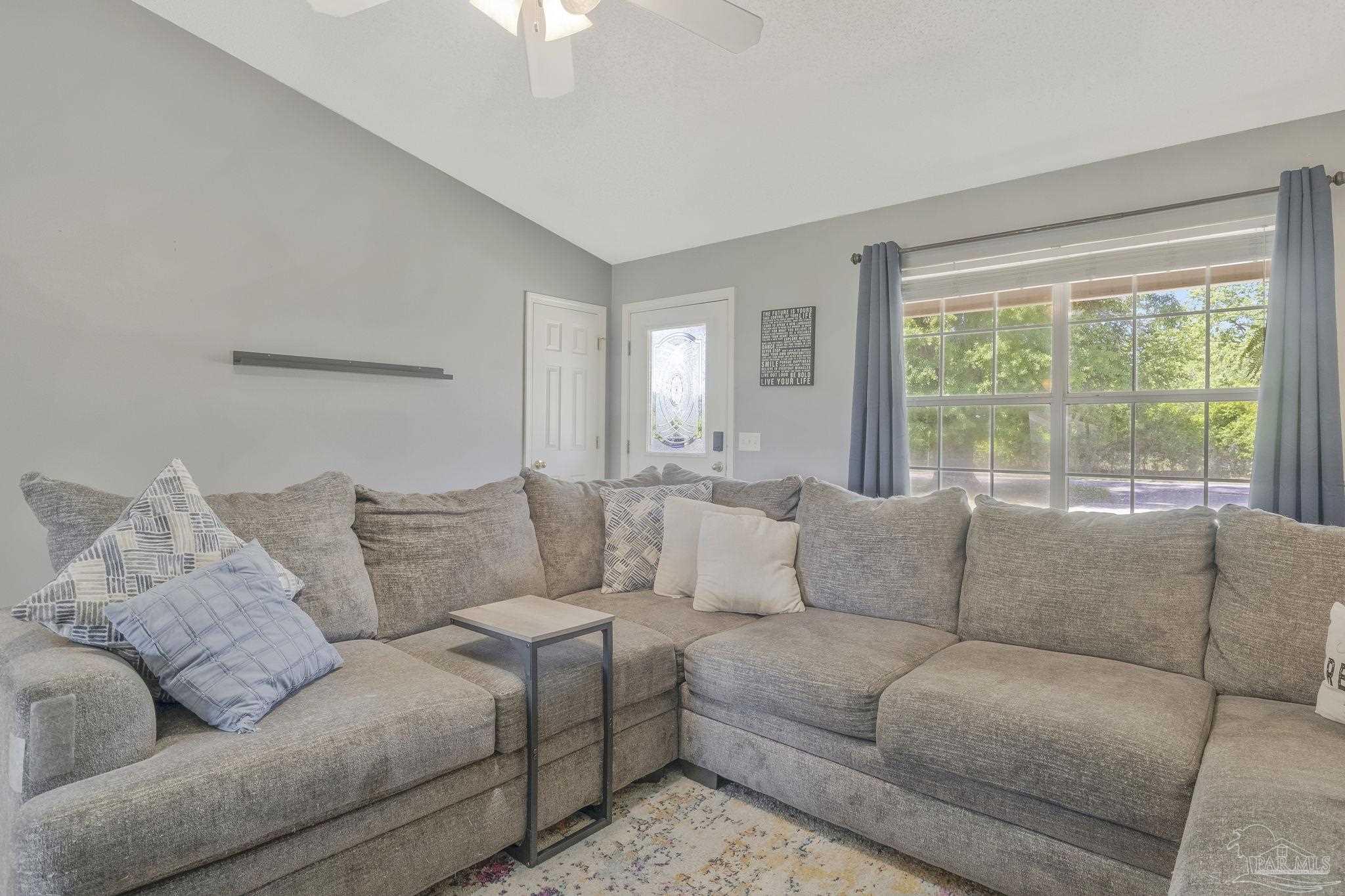 5539 Windrun Place Pace, FL 32571 - Photo 14 of 62 a living room with furniture and a large window