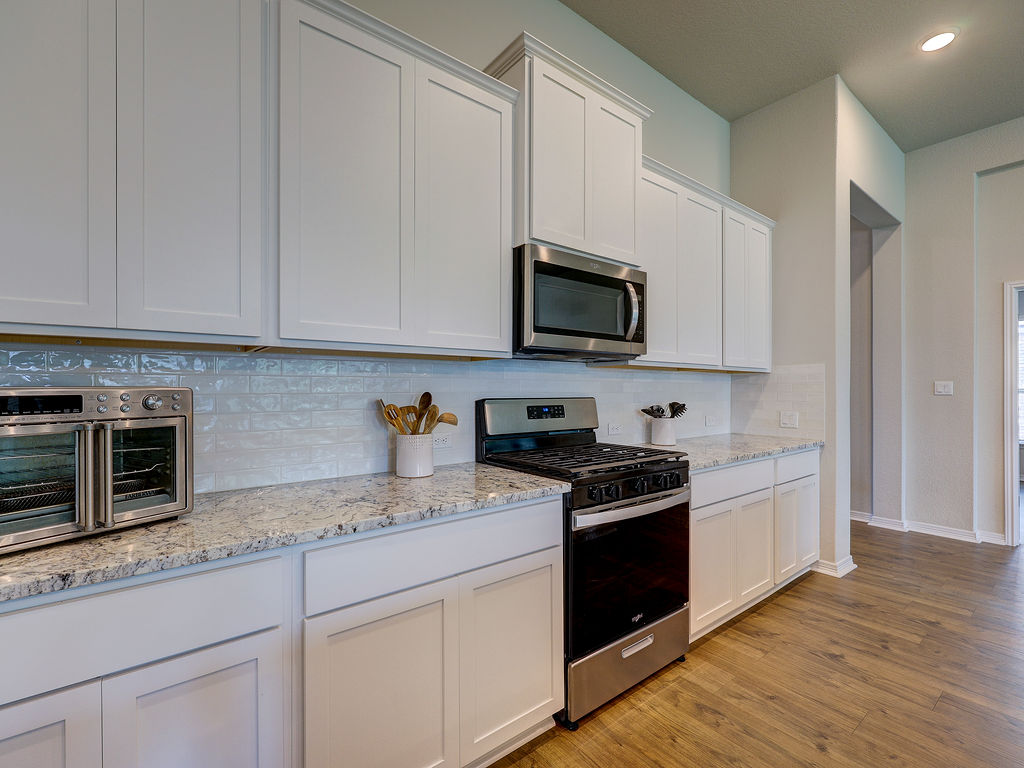 229 Heartleaf Road San Marcos, TX 78666 - Photo 16 of 40 Culinary adventures await in this naturally illuminated kitchen with stainless steel appliances and abundant counter space.