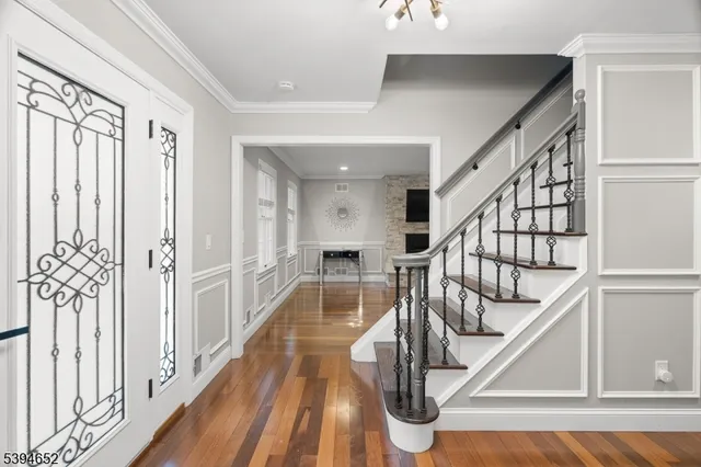 a view of staircase with wooden floor and a chandelier