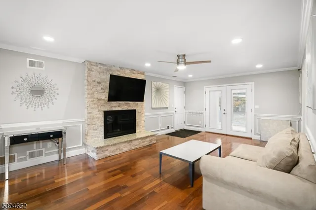 a living room with furniture a fireplace and a flat screen tv