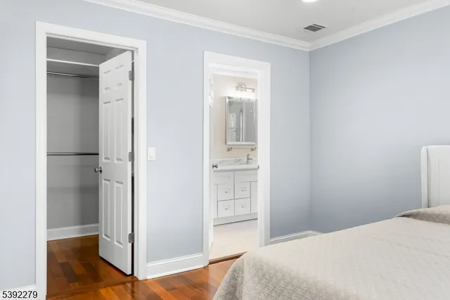 a bedroom with a bed and a mirror