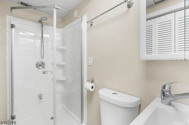 a bathroom with a shower a toilet and a sink