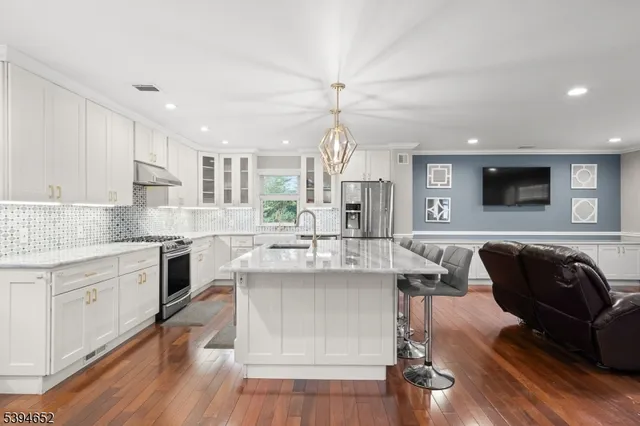 a kitchen with a sink cabinets and wooden floor