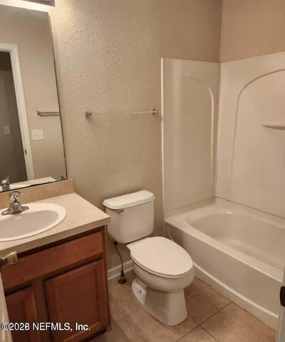 a bathroom with a sink a toilet and a bathtub
