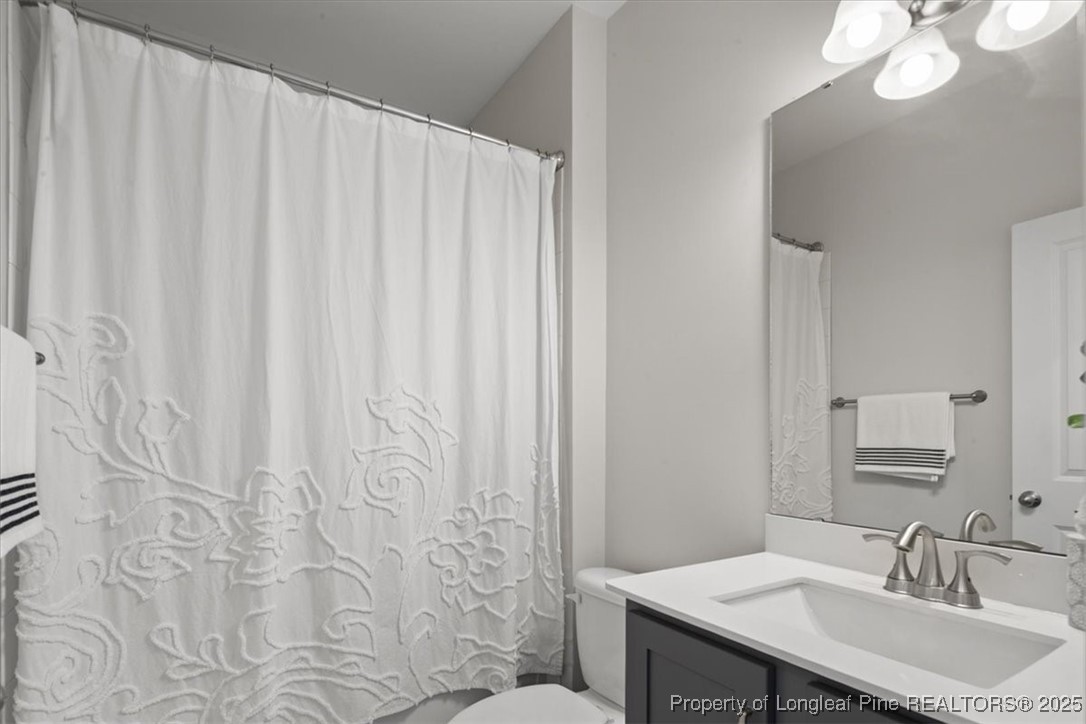 7840 Rufus Johnson Road Fayetteville, NC 28306 - Photo 12 of 50 a bathroom with a sink and a mirror