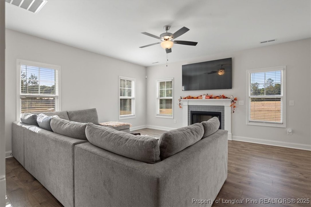 7840 Rufus Johnson Road Fayetteville, NC 28306 - Photo 14 of 50 a living room with furniture a flat screen tv and a fireplace