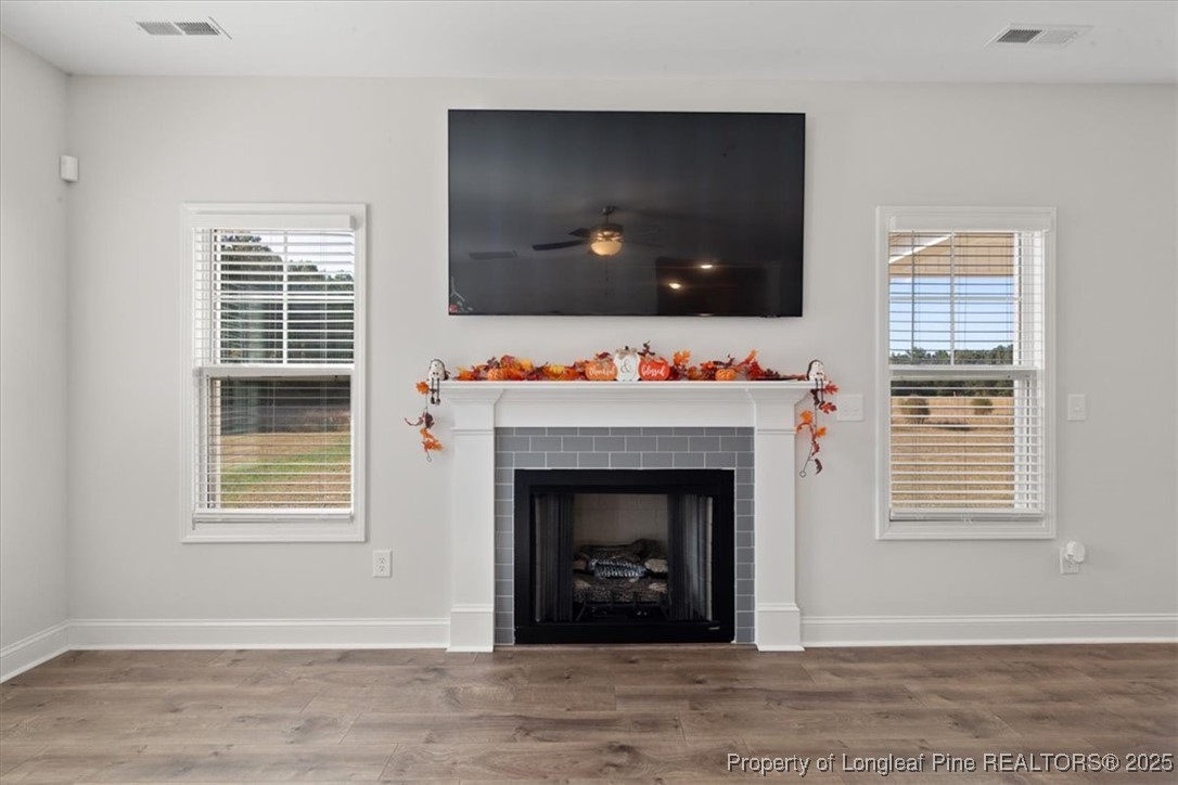 7840 Rufus Johnson Road Fayetteville, NC 28306 - Photo 16 of 50 a living room with fireplace and a flat screen tv