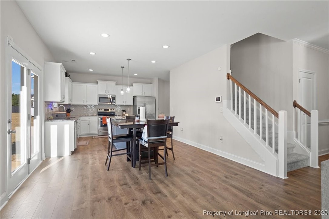 7840 Rufus Johnson Road Fayetteville, NC 28306 - Photo 18 of 50 a view of a dining room with furniture and wooden floor