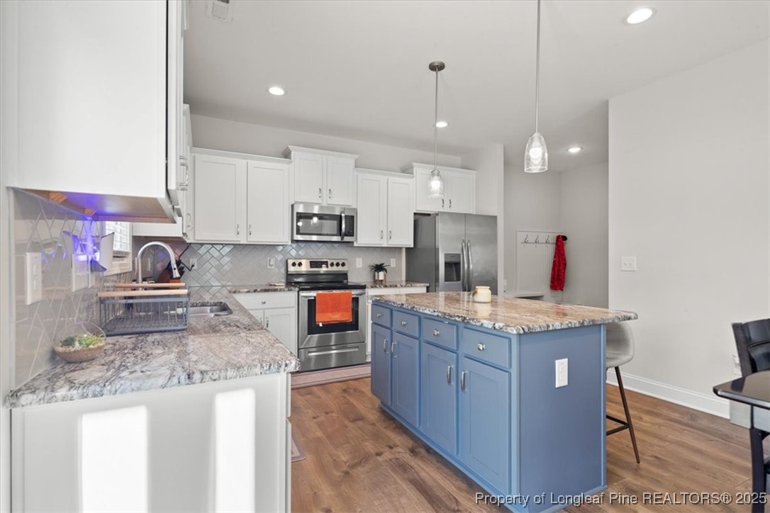 7840 Rufus Johnson Road Fayetteville, NC 28306 - Photo 20 of 50 a kitchen with stainless steel appliances granite countertop a sink stove and refrigerator