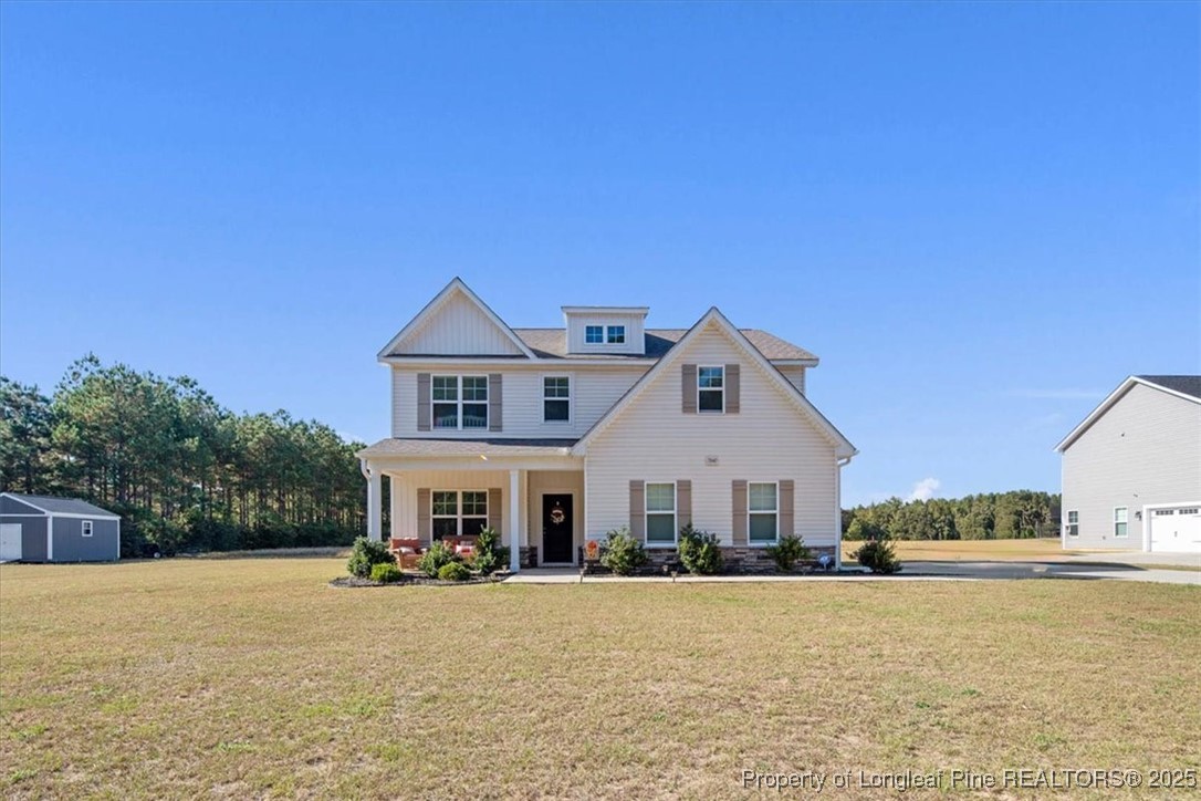 7840 Rufus Johnson Road Fayetteville, NC 28306 - Photo 2 of 50 a front view of a house with a yard and garage