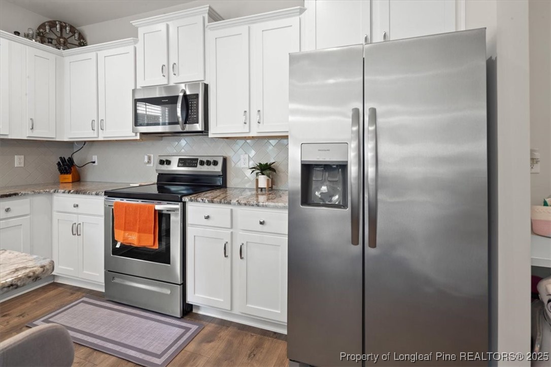 7840 Rufus Johnson Road Fayetteville, NC 28306 - Photo 23 of 50 a kitchen with stainless steel appliances granite countertop a refrigerator a microwave and cabinets