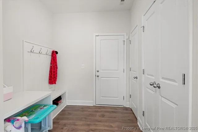 a view of a hallway with a livingroom and entryway