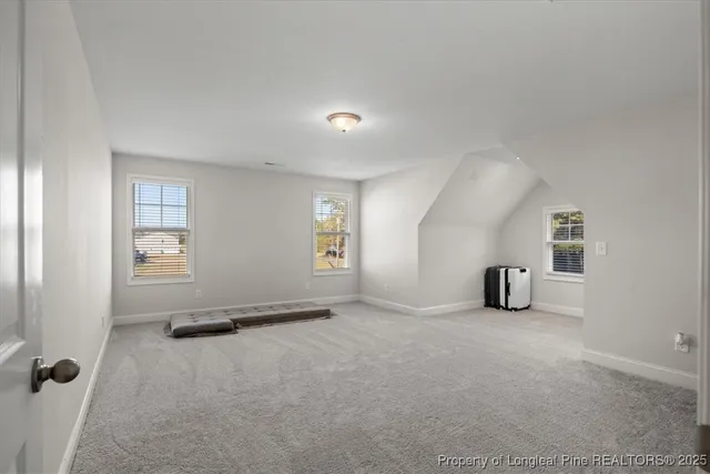 an empty room with windows and natural light
