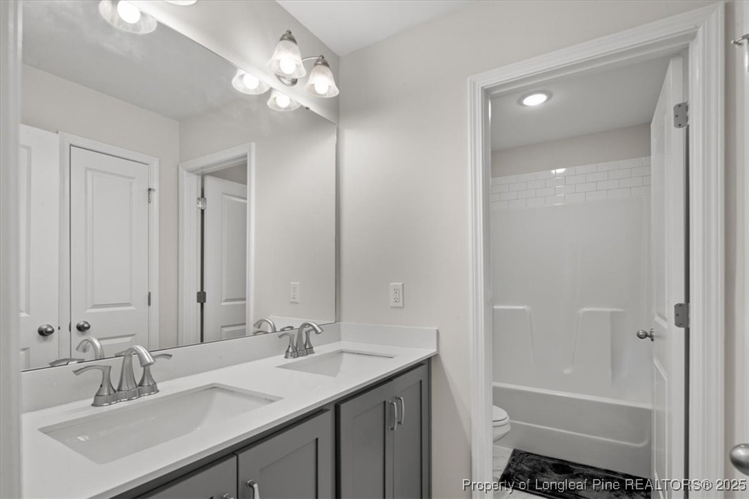 7840 Rufus Johnson Road Fayetteville, NC 28306 - Photo 37 of 50 a bathroom with a sink double vanity and a mirror