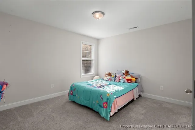 a bedroom with a bed couch and window