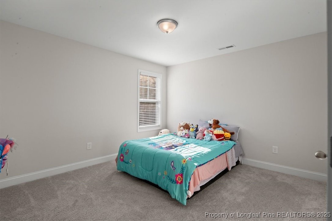 7840 Rufus Johnson Road Fayetteville, NC 28306 - Photo 39 of 50 a bedroom with a bed and window