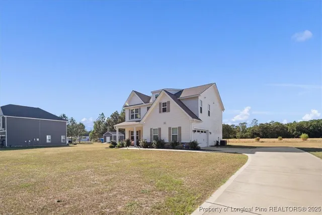 a view of a white house with a yard