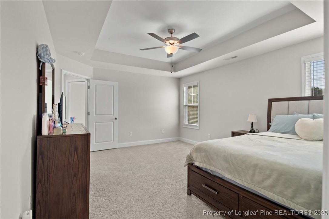 7840 Rufus Johnson Road Fayetteville, NC 28306 - Photo 43 of 50 a bedroom with a bed and a chandelier