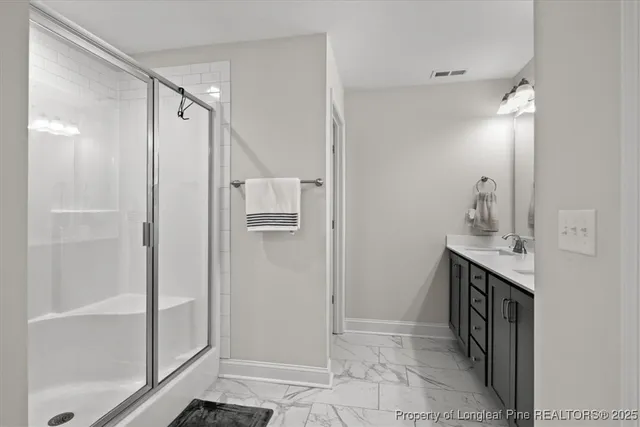 a bathroom with a shower and a sink